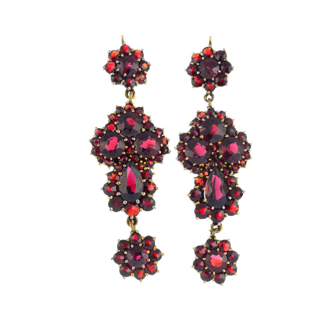 A pair of garnet earrings. Each designed as a series of (1 of 2)