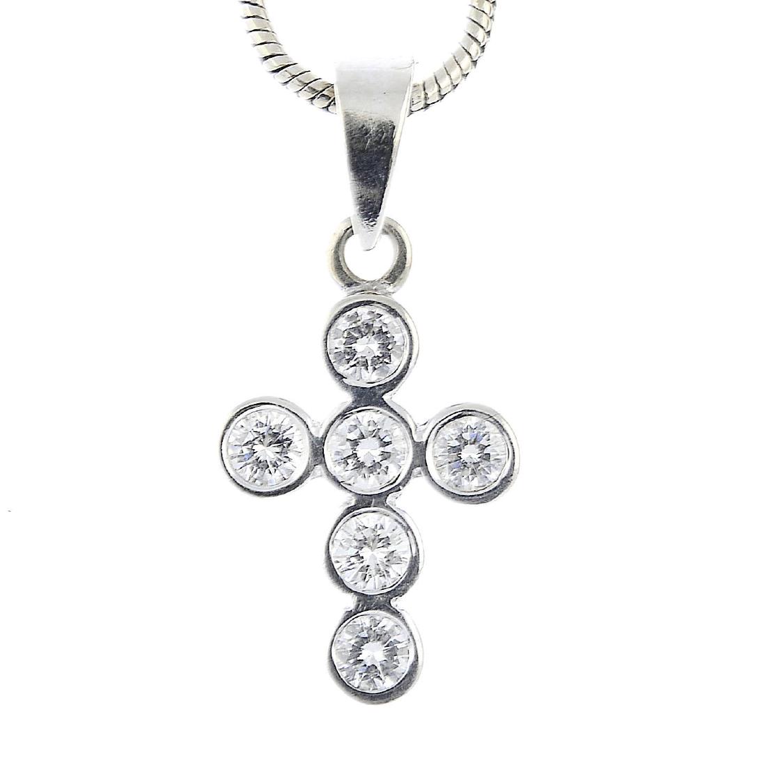 An 18ct gold diamond cross pendant. Designed as a (1 of 3)