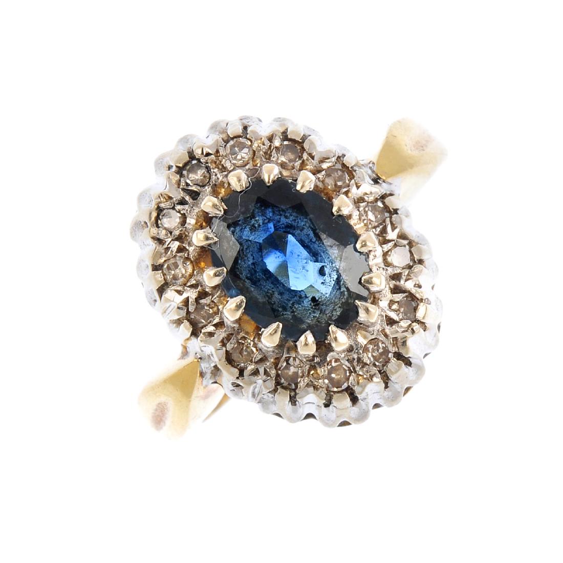 An 18ct gold sapphire and diamond cluster ring. The (1 of 3)