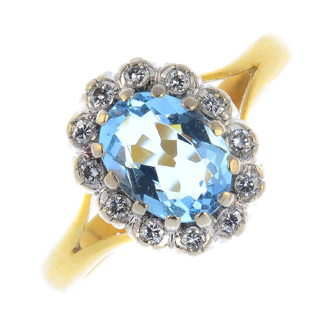 An 18ct gold diamond and aquamarine cluster ring. The (1 of 3)