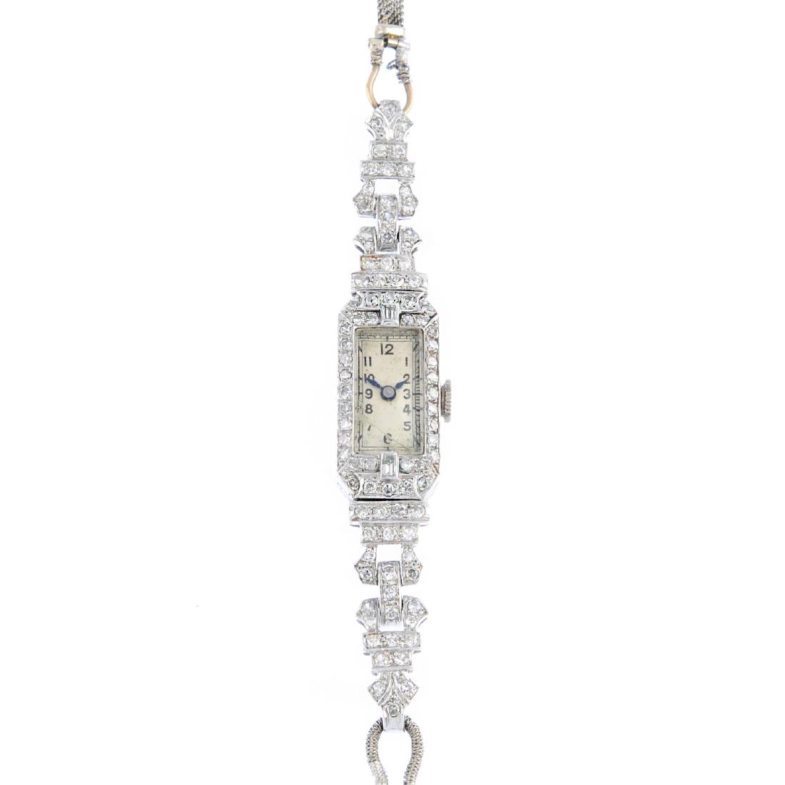 An Art Deco platinum and gold diamond cocktail watch. (1 of 3)