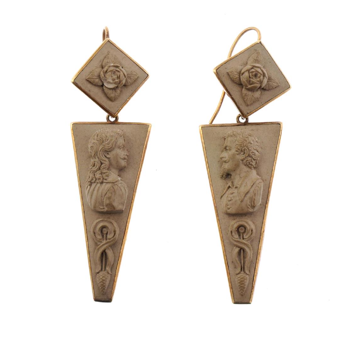 A pair of lava cameo earrings. Each designed as a (1 of 2)