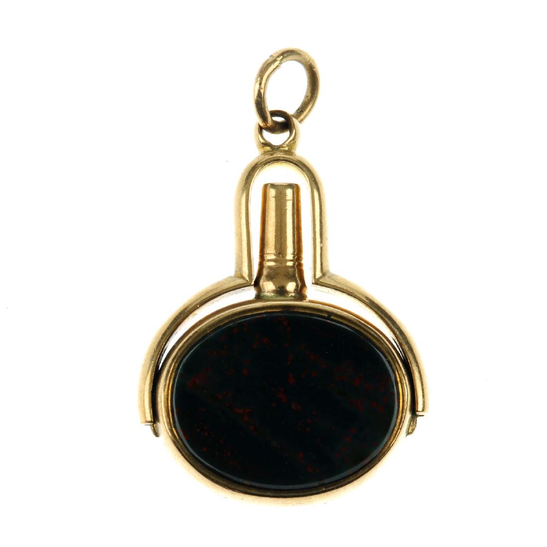 A late Victorian gold swivel watch key. The oval-shape: A late Victorian gold swivel watch key. The oval-shape fob with bloodstone set to one side, a carnelian to the other, the watch-key folding away to the raised pedestal. Hallmark for Birmingham, 1900.