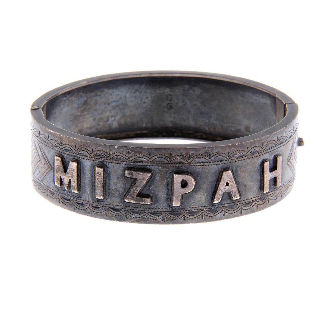 A late Victorian silver hinged bangle. The front bangle (1 of 2)