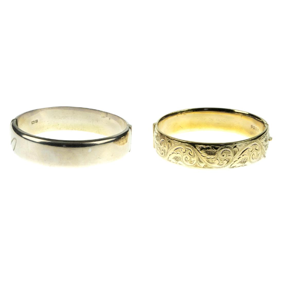 Six silver and white metal hinged bangles. To include a (1 of 2)