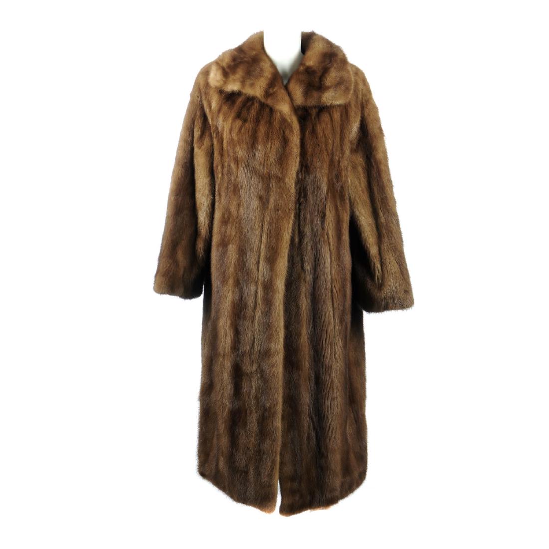 A full-length demi-buff mink coat. Designed with a (1 of 2)