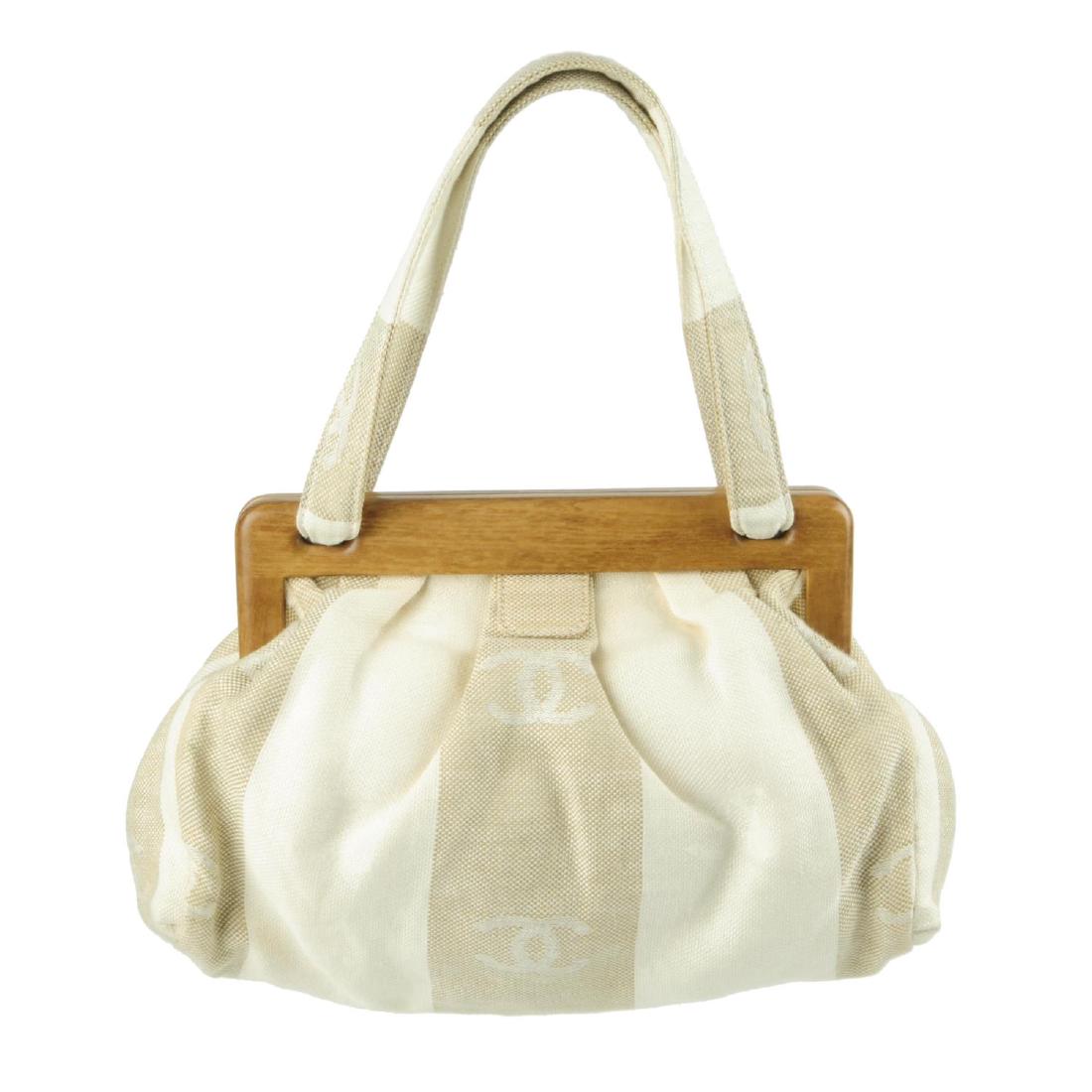 CHANEL - a white and beige canvas handbag. Designed (1 of 8)