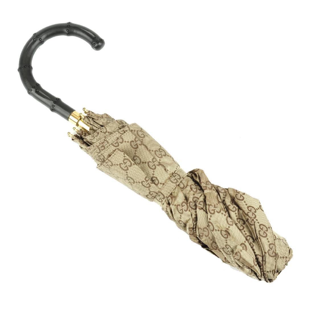 GUCCI a Monogram GG umbrella. Designed with a beige