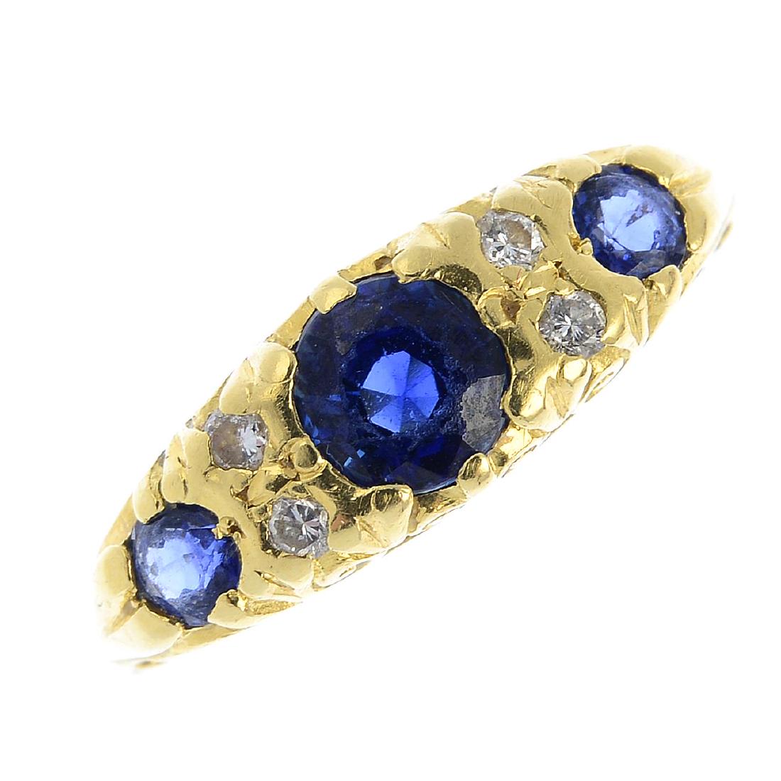 An 18ct gold diamond and sapphire ring. The graduated (1 of 3)