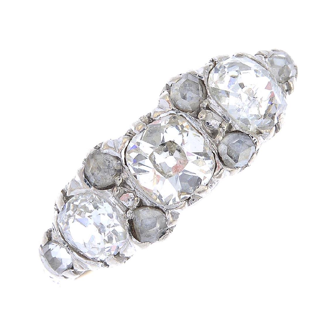 A diamond three-stone ring. The old-cut diamond line, (1 of 3)
