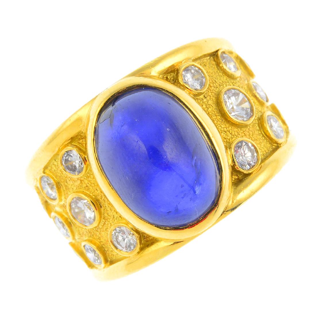 JULIUS COHEN - a star sapphire and diamond dress ring.: JULIUS COHEN - a star sapphire and diamond dress ring. Designed as an oval star sapphire cabochon, to the textured and tapered band, with scattered brilliant-cut diamond collet highlights. Signed Juli
