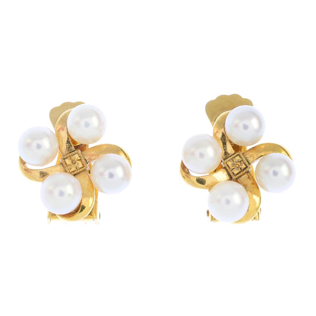MIKIMOTO - a pair of cultured pearl earrings. Each: MIKIMOTO - a pair of cultured pearl earrings. Each designed as a cultured pearl quatrefoil, with scrolling cross and textured panel highlight. Maker's marks for Mikimoto. Length 1.6cms. Weight 6.2gms.