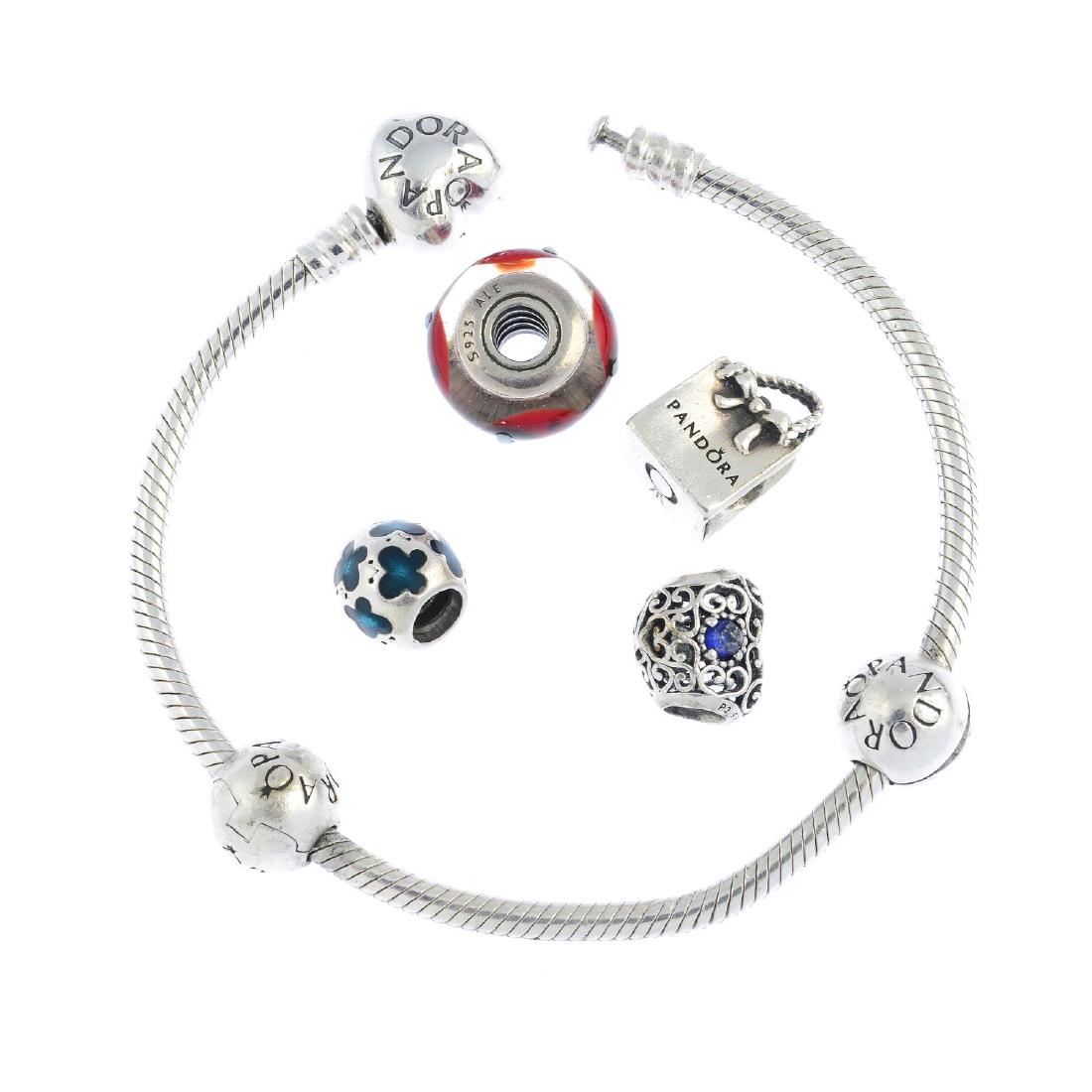 PANDORA - two charm bracelets and eighteen charms. One: PANDORA - two charm bracelets and eighteen charms. One bracelet with barrel-shape clasp and two charms, a further ten loose charms including a snowman and a heart, together with a bracelet with heart-