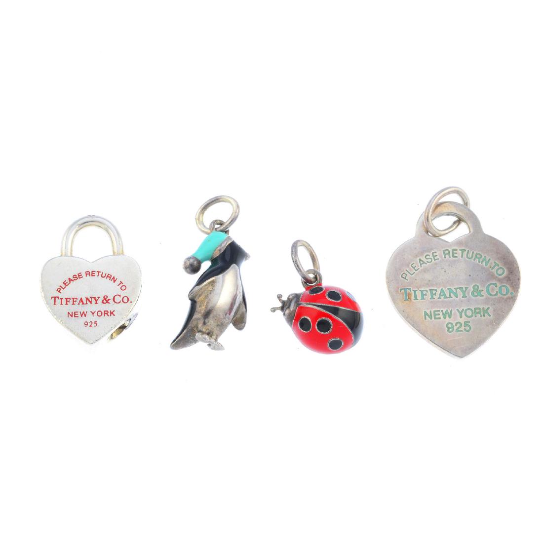 TIFFANY & CO. - four enamel charms. To include a silver (1 of 2)