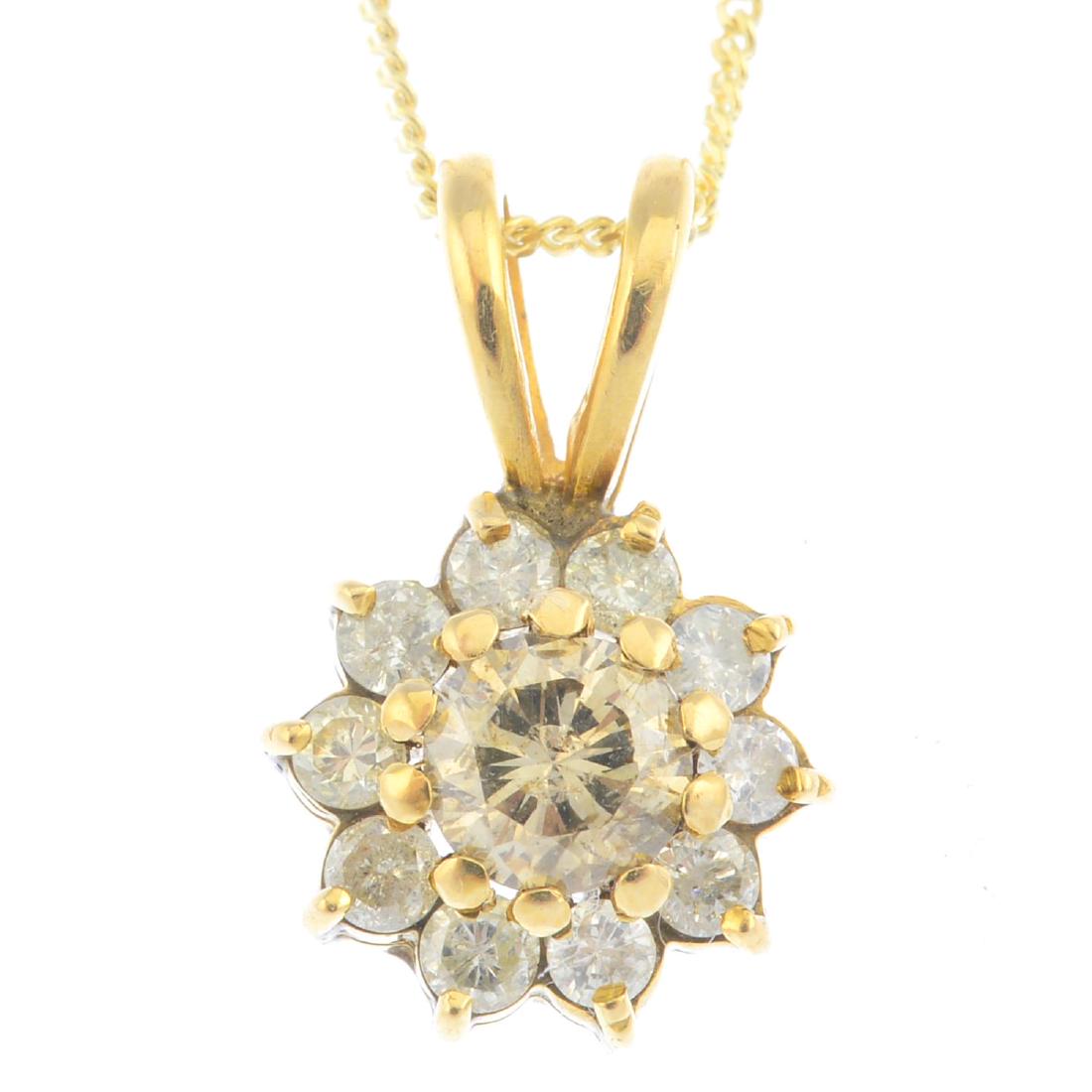 A diamond cluster pendant. The brilliant-cut diamond, (1 of 3)