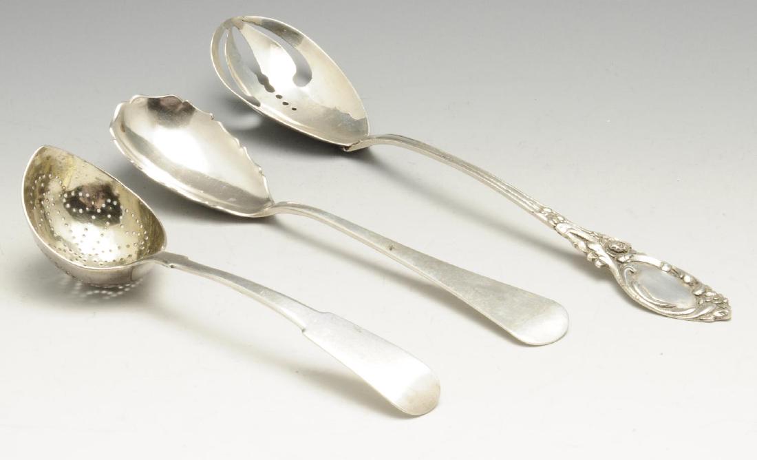 A selection of flatware to include a Russian silver: A selection of flatware to include a Russian silver ladle, of Fiddle pattern style, the slightly pointed bowl with simple drilled holes, marked 84 alongside a city mark for St Petersburg (1818-1864) a