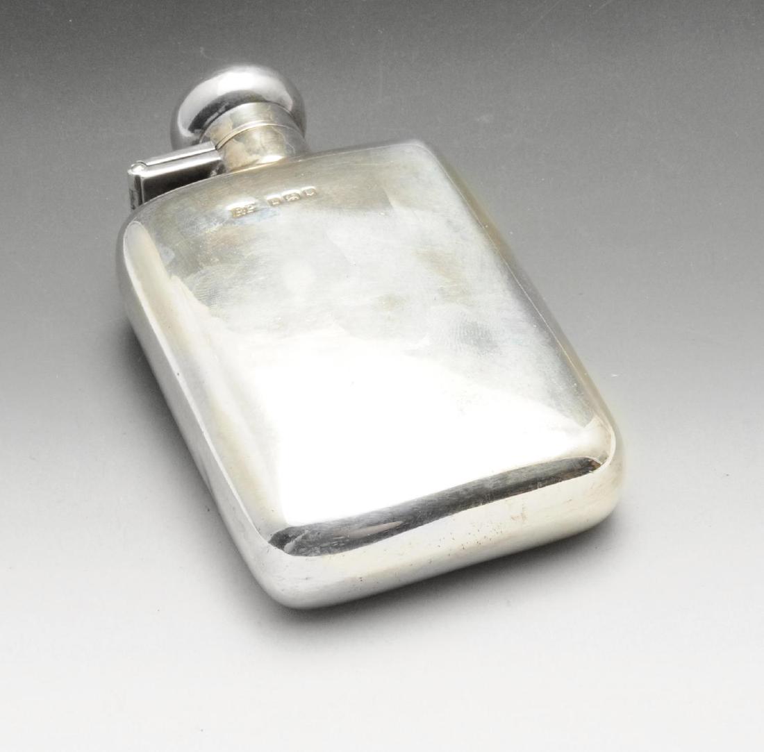 A mid-twentieth century small silver hip flask, of: A mid-twentieth century small silver hip flask, of plain slightly curved oblong form with bayonet lock mechanism to the globular lid. Hallmarked Robert Pringle & Sons, London 1946. Length measuring 4 