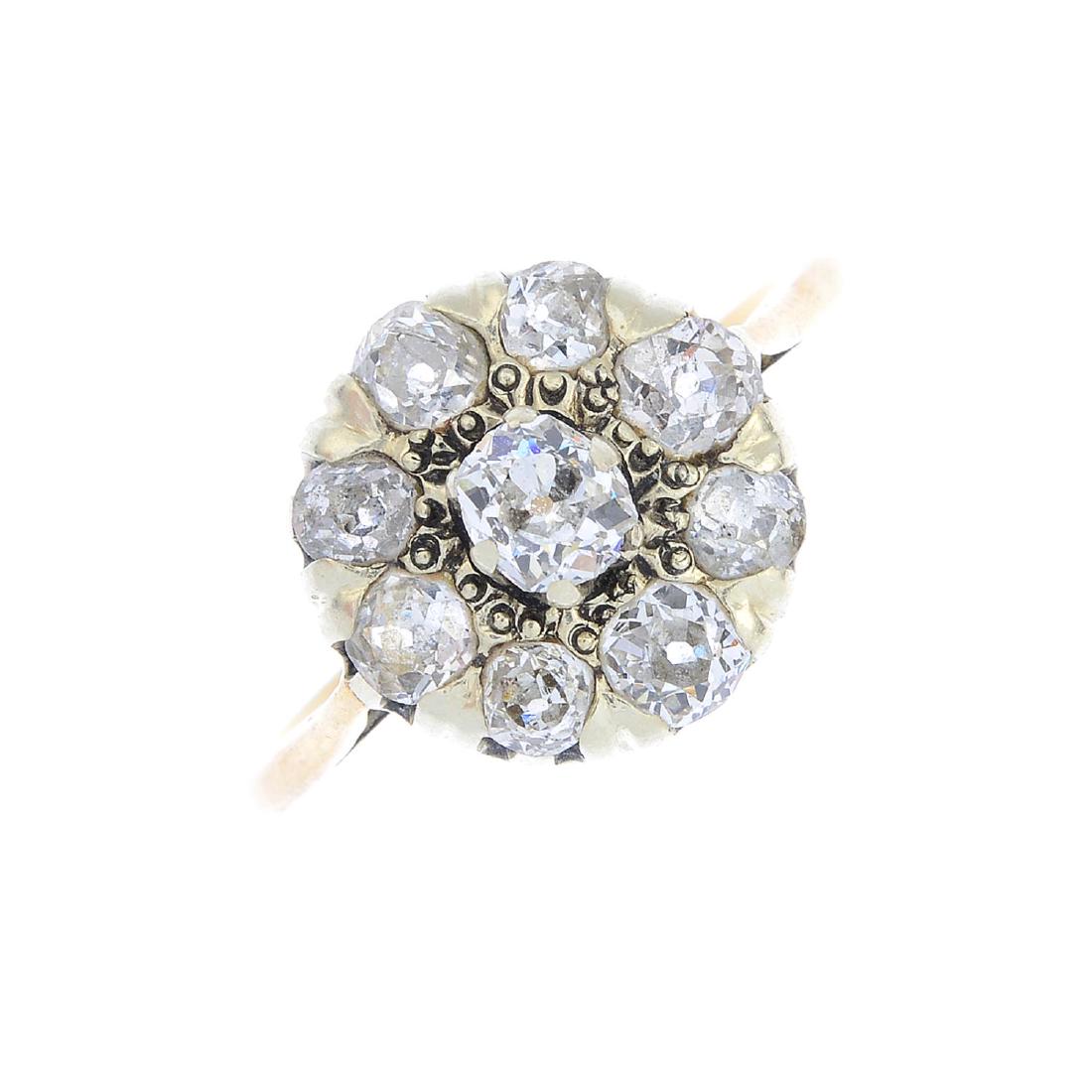 A diamond cluster ring. The old-cut diamond, raised (1 of 3)