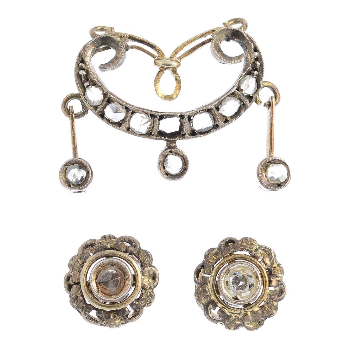 A diamond pendant and a pair of earrings. The pendant, (1 of 2)