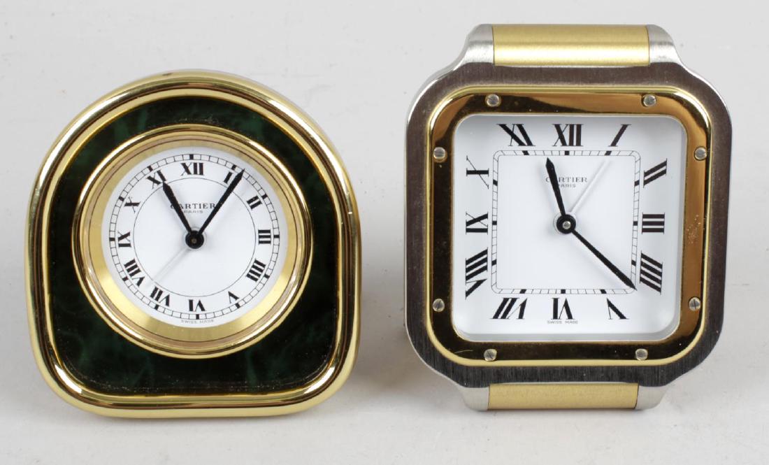 A Cartier Santos desk alarm clock, the brushed steel: A Cartier Santos desk alarm clock, the brushed steel and gilt metal finished case with white dial and black Roman numerals, with easel style support, impressed number to back 7508-11867, 3.5 (9cm) hig