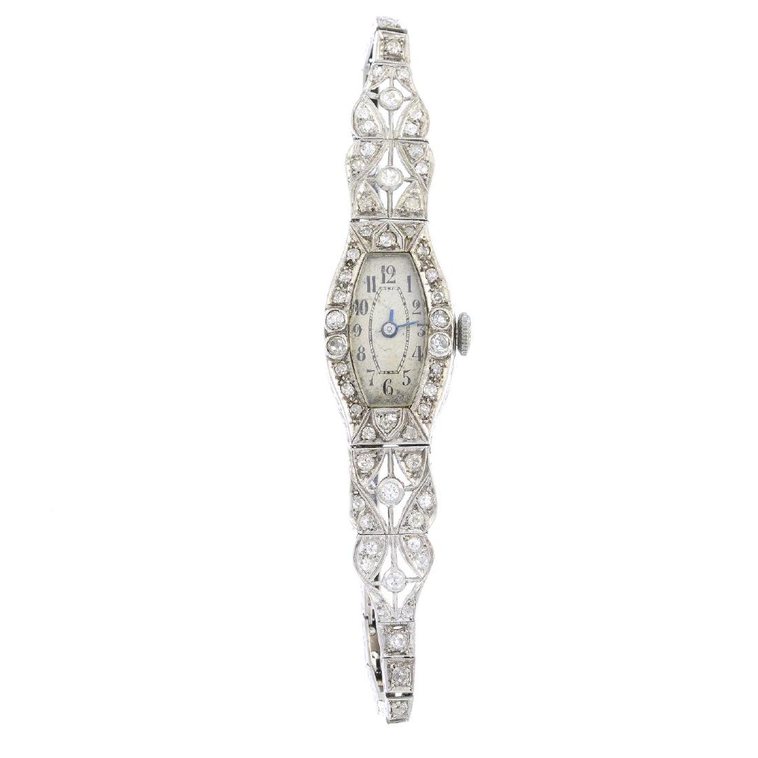 A diamond cocktail watch. The tonneau-shape dial with (1 of 3)