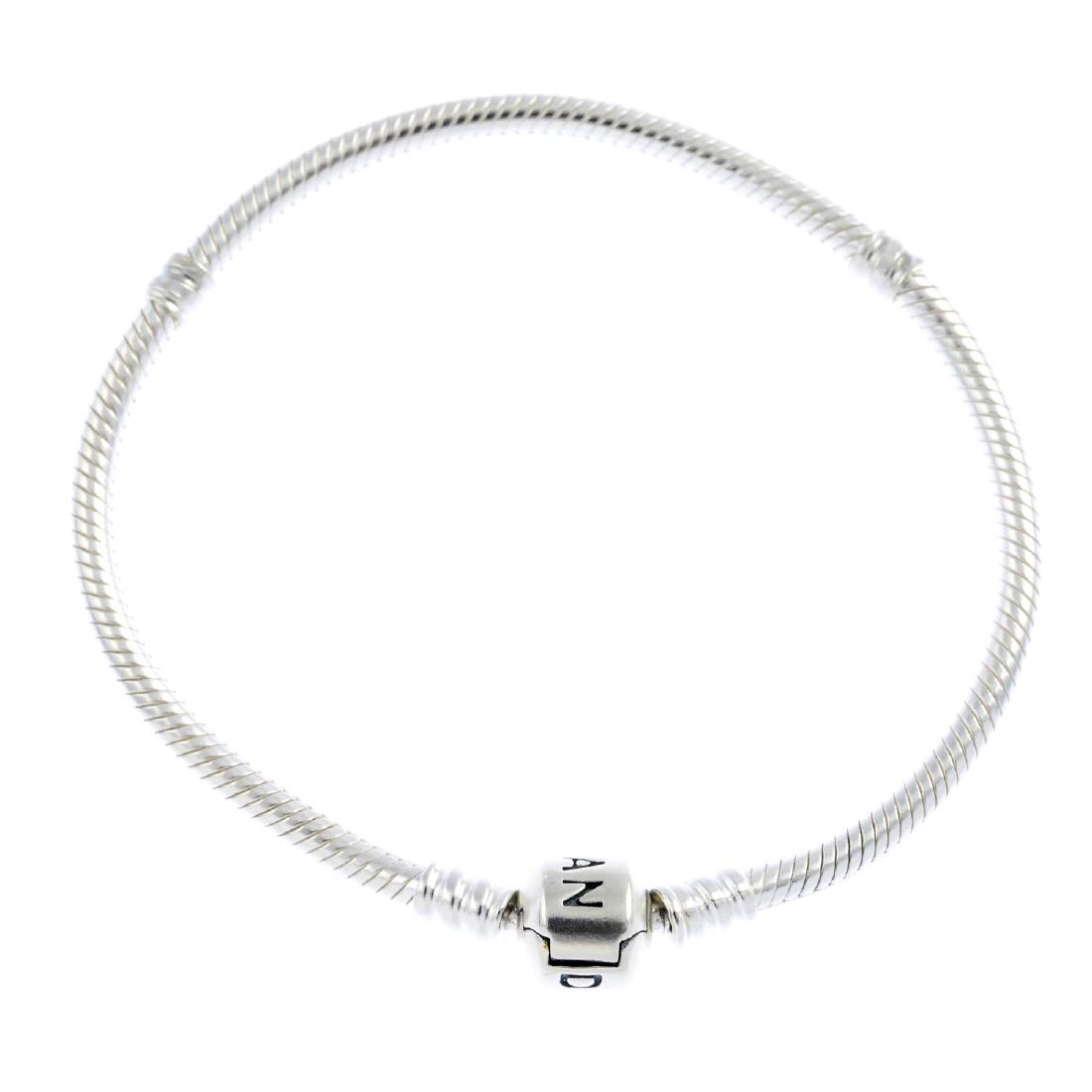 PANDORA - a selection of jewellery. To include a: PANDORA - a selection of jewellery. To include a snake-link necklace, four snake-link bracelets, suspending an openwork spherical charm and a loose gem-set yin yang enamel charm. Maker's marks for Pan
