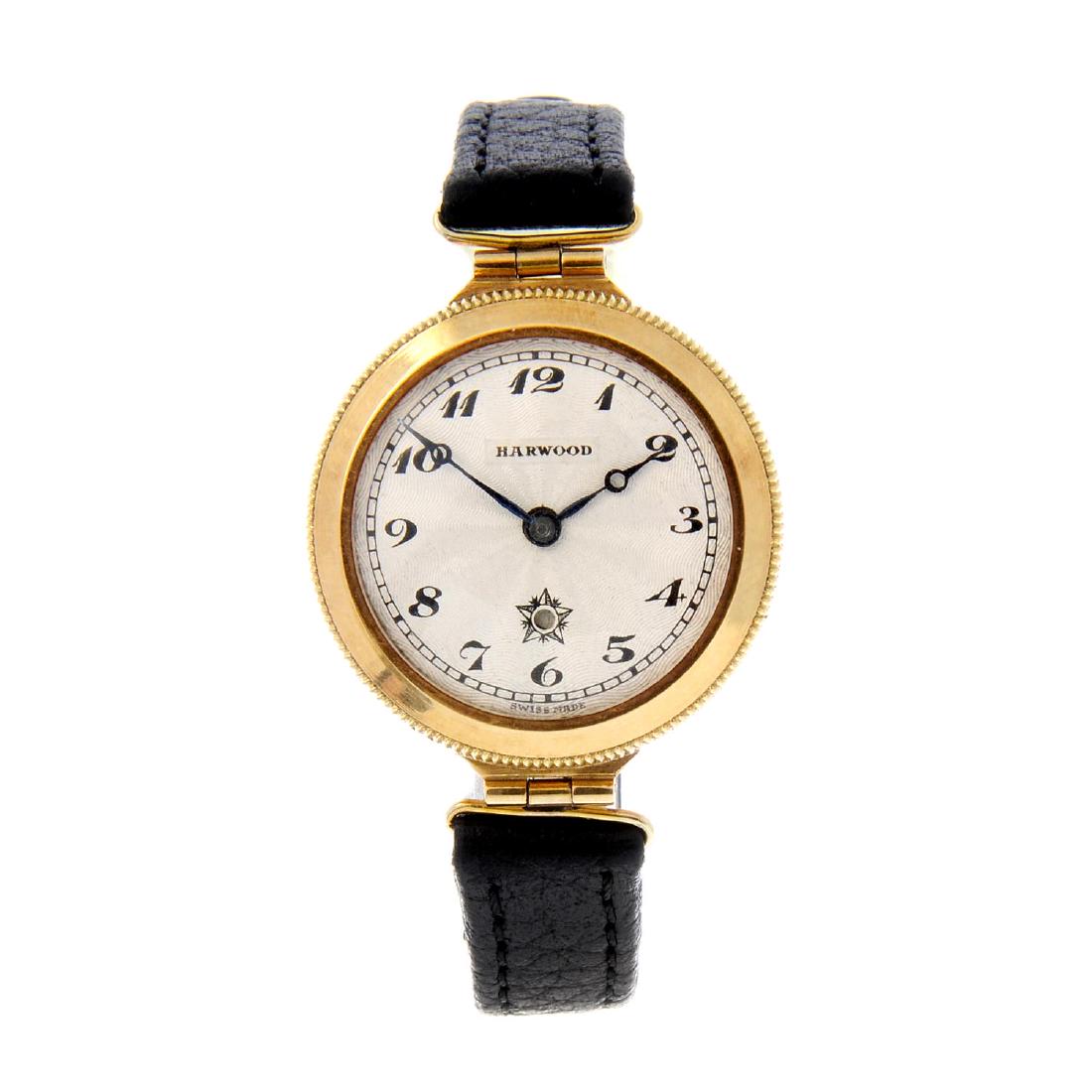 HARWOOD - a wrist watch. 18ct yellow gold case, import: HARWOOD - a wrist watch. 18ct yellow gold case, import hallmarked London 1929. Numbered 92748. Signed bumper automatic movement. Silvered dial with Arabic numeral hour markers. Fitted to an unsigned b