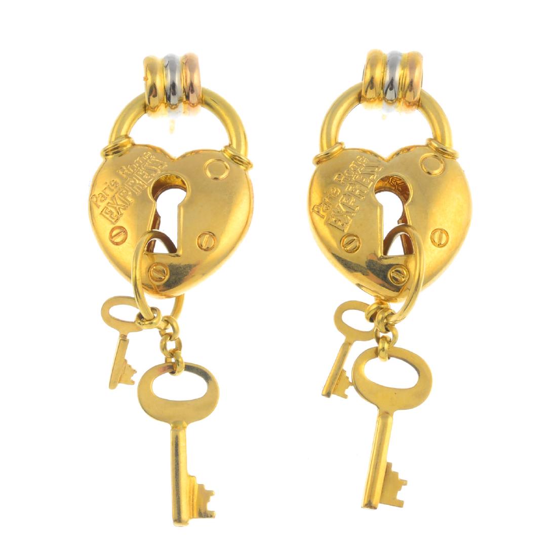 A pair of heart and key earrings. Each designed as a (1 of 2)