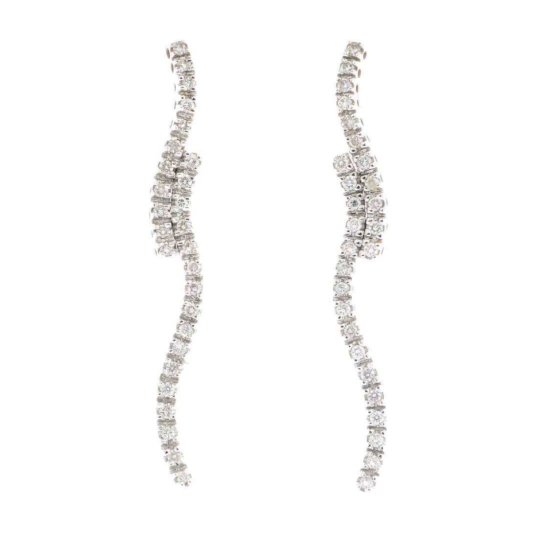 A pair of 18ct gold diamond earrings. Each designed as (1 of 2)