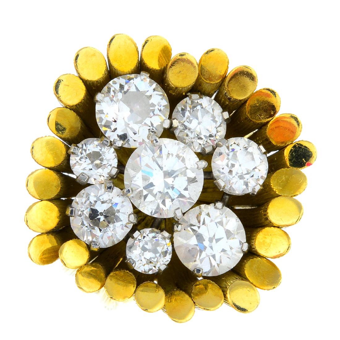 GRIMA - a 1970s 18ct gold diamond ring. The old and: GRIMA - a 1970s 18ct gold diamond ring. The old and brilliant-cut diamond scattered cluster, nestled within a textured bar surround, to the similarly textured and grooved band. Signed Grima. Estimated