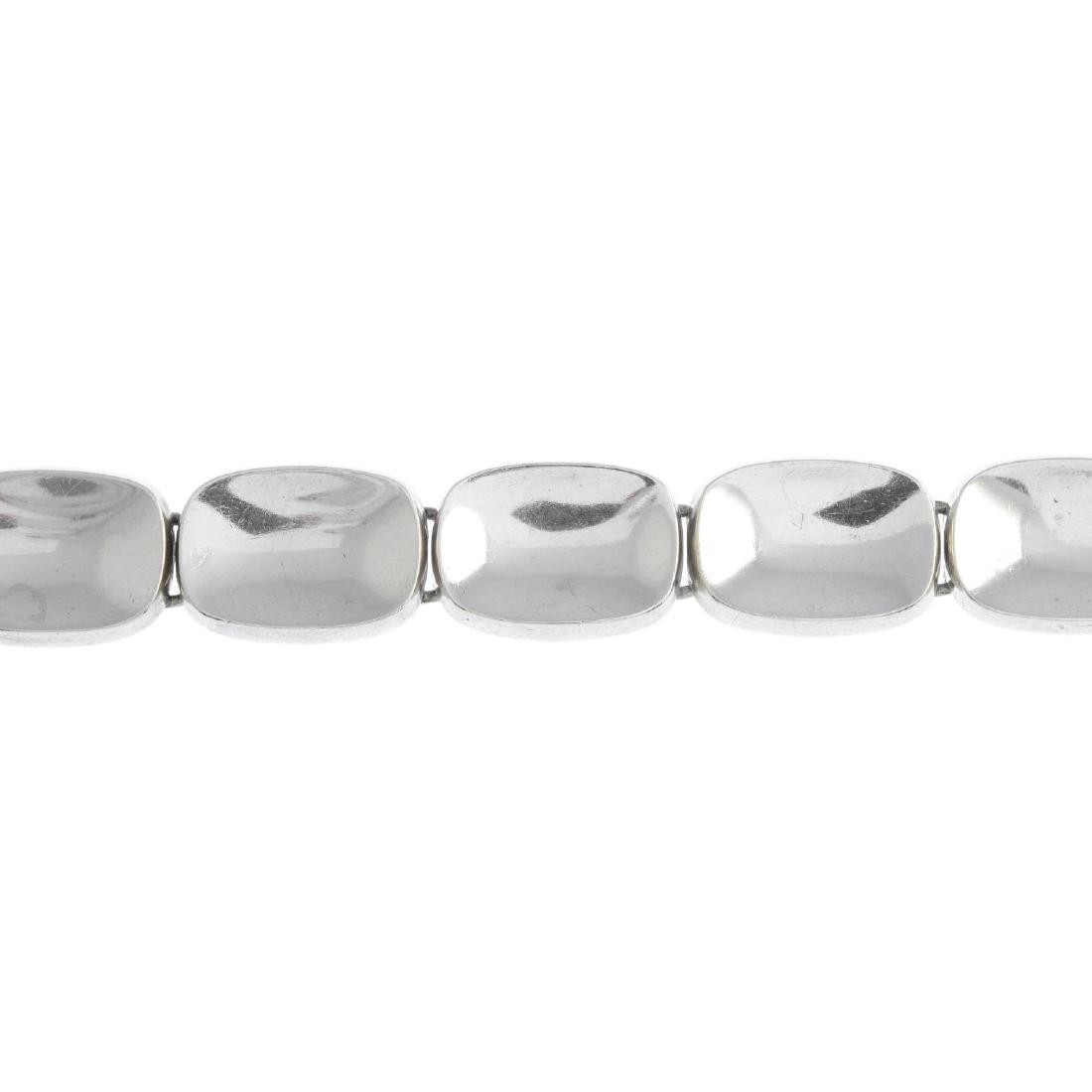 BENT KNUDSEN - a silver bracelet. Comprising a series: BENT KNUDSEN - a silver bracelet. Comprising a series of curved cushion-shape links, with concealed hook clasp and grooved spherical screw securing mechanism. Maker's marks for Bent Knudsen. 17.7cms.