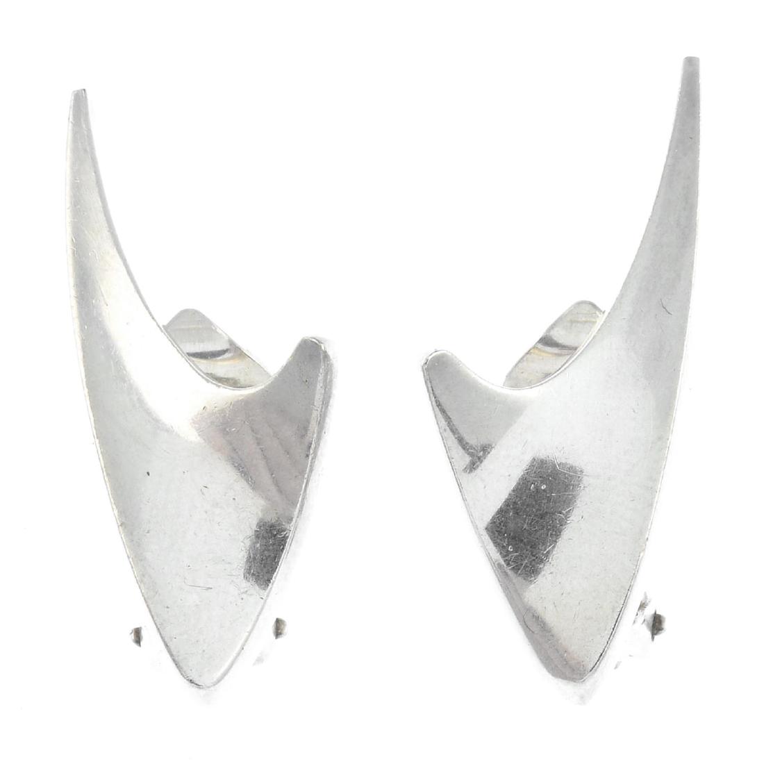 BENT KNUDSEN - a pair of silver earrings. Each designed: BENT KNUDSEN - a pair of silver earrings. Each designed as a curved and tapered chevron. Maker's marks for Bent Knudsen. Length 3.1cms. Weight 9.5gms.