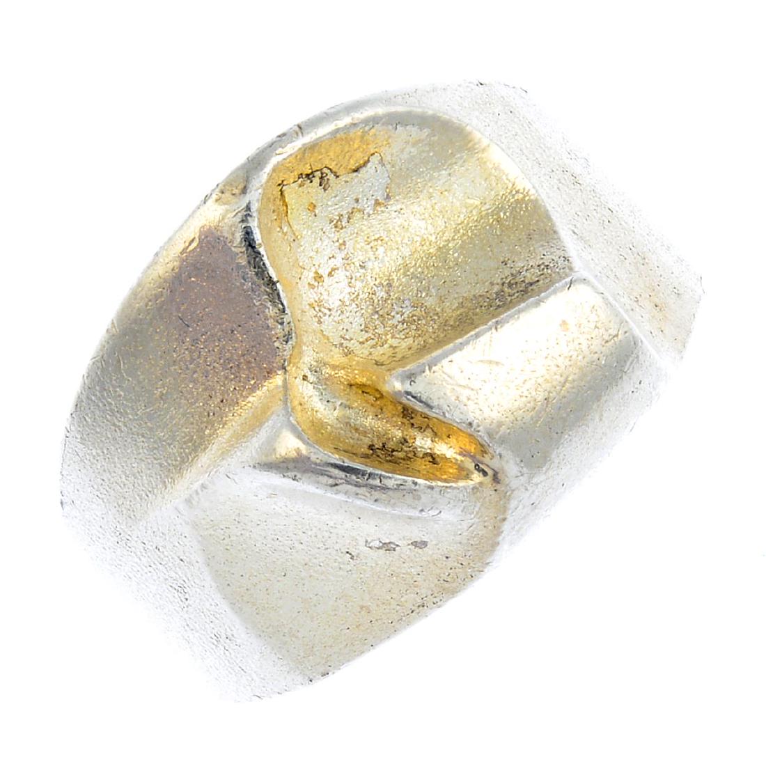 A selection of Scandinavian silver rings. To include an: A selection of Scandinavian silver rings. To include an open band ring by Ole Lynggaard, a textured abstract ring by Lapponia, an amethyst dress ring, a colourless gem band ring, together with a furth