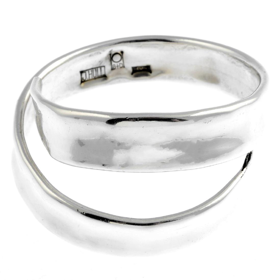 BUCH & DEICHMANN - a silver bangle. Designed as a: BUCH & DEICHMANN - a silver bangle. Designed as a spiral cuff, with tapered terminals. Designed by Jacob Hull. Maker's marks for Buch & Deichmann. Inner diameter 6.2cms. Weight 100.3gms.