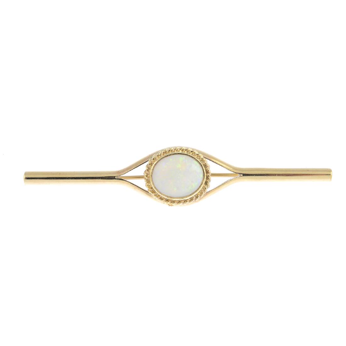 An opal bar brooch. The oval opal cabochon, within a (1 of 2)