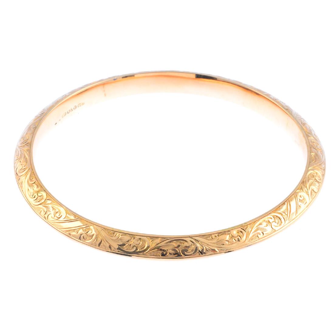 A mid 20th century 9ct gold tapered bangle, with (1 of 2)