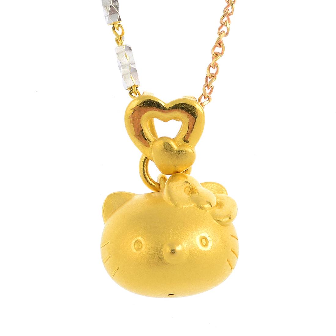 (21352) A jade ring and a 'Hello Kitty' pendant, with a: (21352) A jade ring and a 'Hello Kitty' pendant, with a chain. The ring designed as a jadeite collet, with scrolling shoulders, the pendant designed as a textured 'Hello Kitty' head with bow, suspende