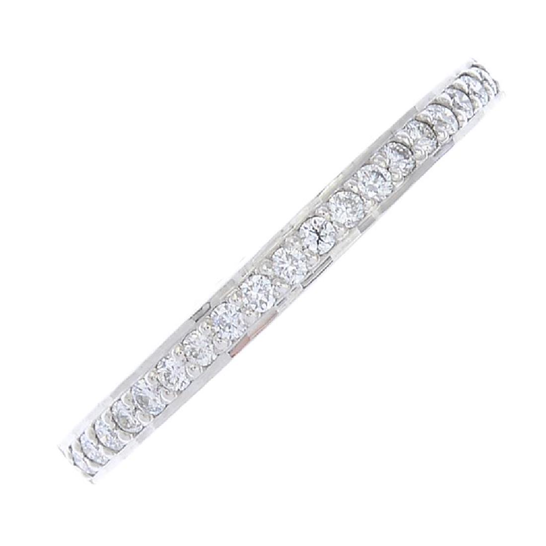 An 18ct gold diamond half eternity ring. The (1 of 3)