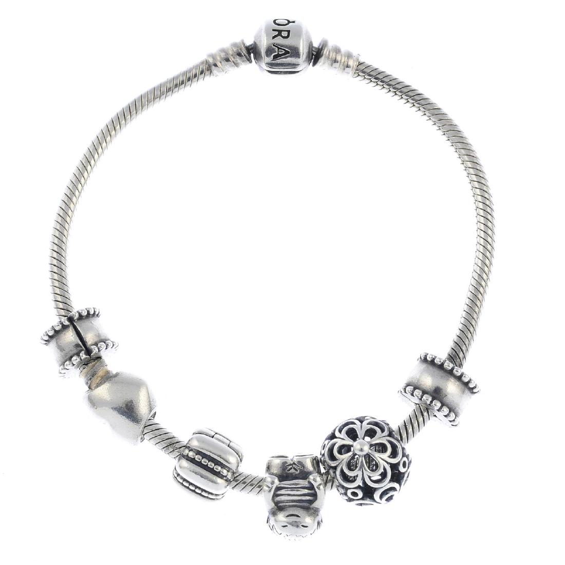 PANDORA - three bracelets and a selection of designer: PANDORA - three bracelets and a selection of designer and non-designer charms. To include three Pandora snake-link bracelets, with nine Pandora charms, a Links of London charm and three further non-de