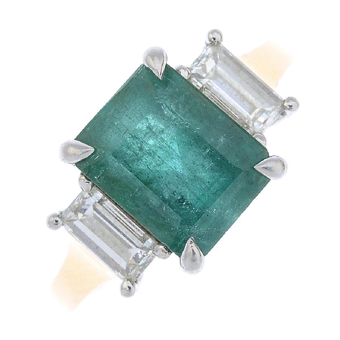 An 18ct gold emerald and diamond three-stone ring. (1 of 3)