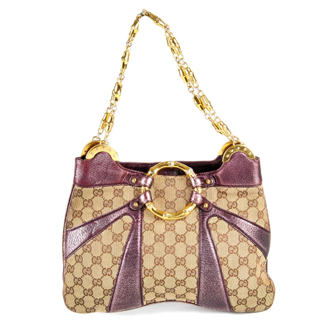 GUCCI by Tom Ford - a Monogram Bamboo Chain handbag.: GUCCI by Tom Ford - a Monogram Bamboo Chain handbag. Crafted from maker's classic GG canvas and metallic purple leather trim, featuring decorative gold-tone bamboo hardware to include a large central