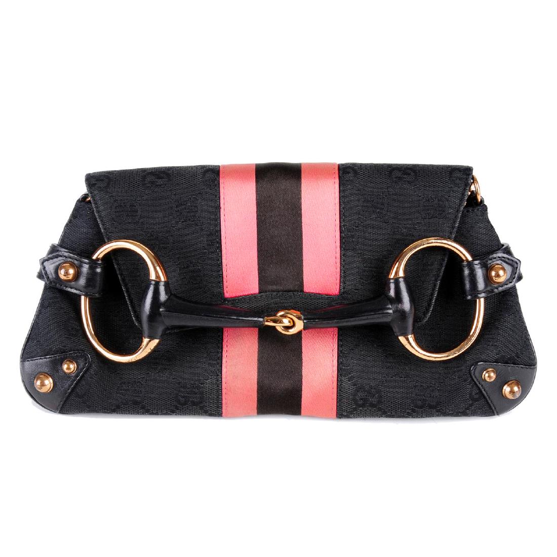 GUCCI by Tom Ford - a Horsebit clutch. Designed with: GUCCI by Tom Ford - a Horsebit clutch. Designed with maker's black monogram canvas exterior and smooth black leather trim, with bronze-tone hardware accents, a neon pink and black central satin stripe