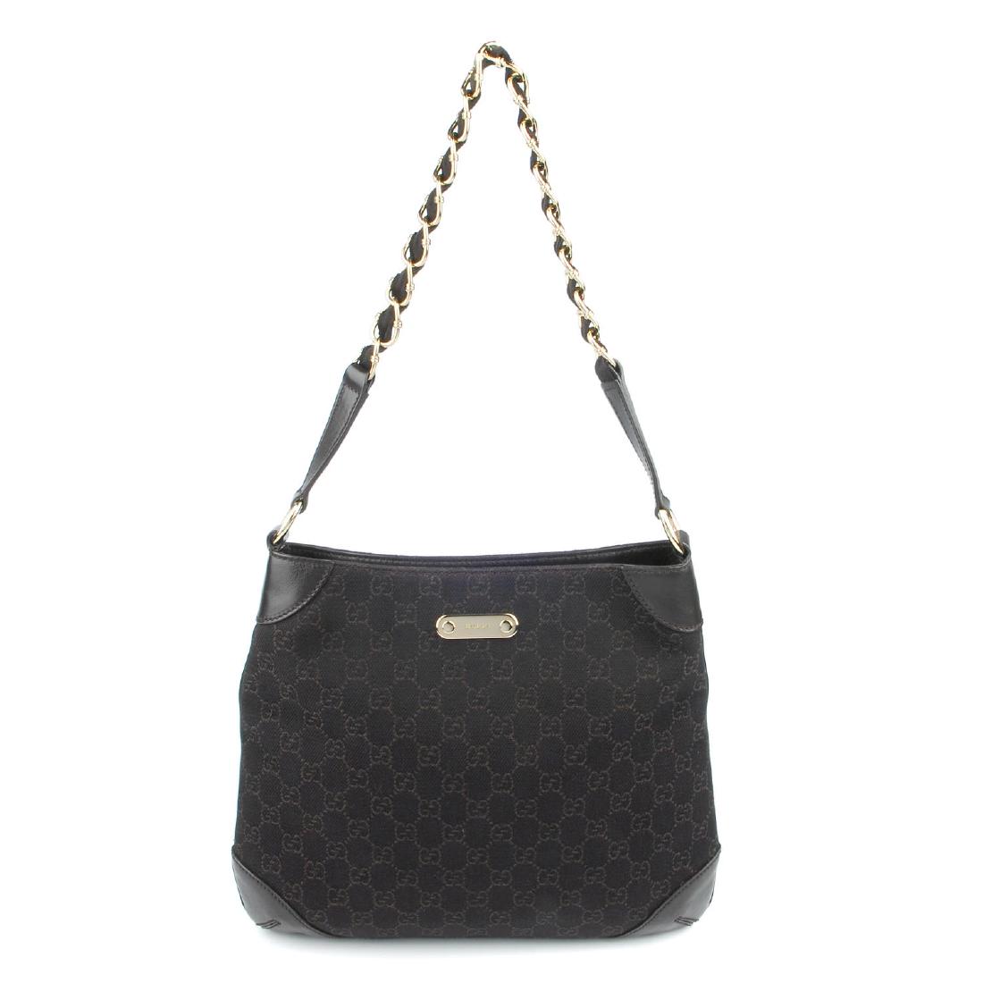 GUCCI - a GG canvas handbag. Featuring a dark brown (1 of 6)