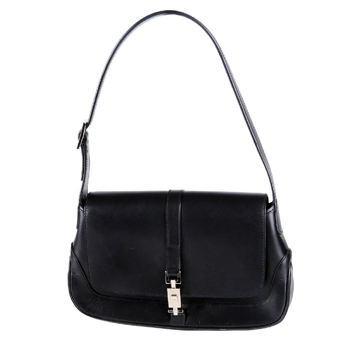 GUCCI - a black Jackie Flap handbag. Designed with a (1 of 4)