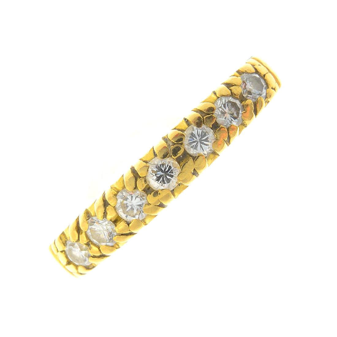 An 18ct gold diamond seven-stone ring. The (1 of 3)