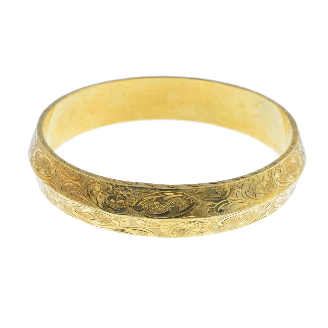 A late 19th century 14ct gold bangle. Designed as a (1 of 2)