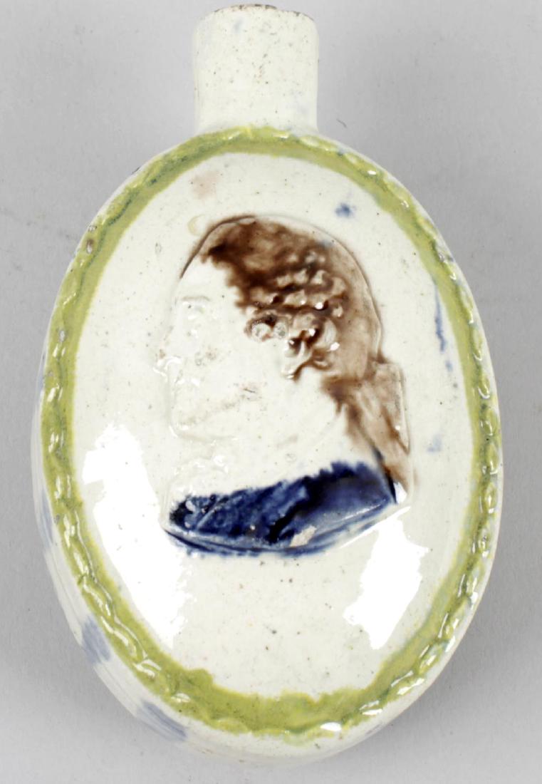 An unusual 19th century Staffordshire pottery flask,: An unusual 19th century Staffordshire pottery flask, the oval shaped body with applied moulded head and shoulder portrait panels to front and reverse, the cream coloured ground with green painted bord