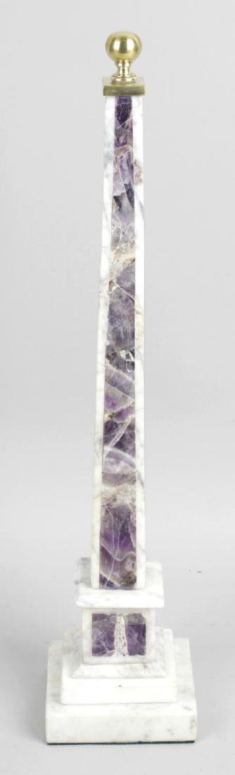 A white marble and fluorite panel inlaid obelisk, with: A white marble and fluorite panel inlaid obelisk, with turned brass finial and stepped plinth base, 16 (40.5cm) high.
