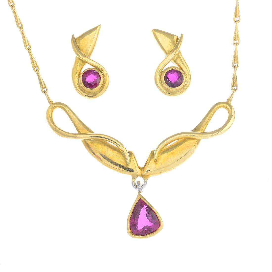 An 18ct gold ruby necklace and earrings. The necklace (1 of 2)