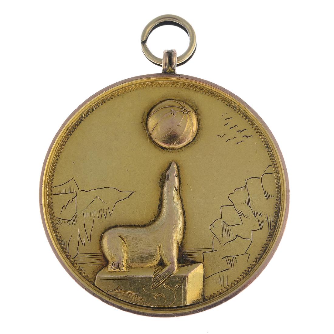 An early 20th century gold sea lion medallion. Of (1 of 2)